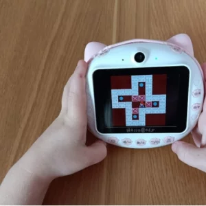 A child's hands playing Push Box on the HelloBaby Instant Print Camera