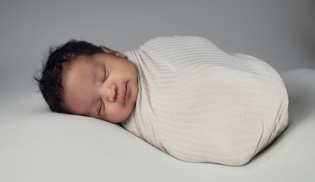 a sleeping swaddled baby