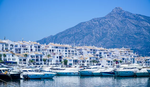a view of Marbella marina with mountains in the background