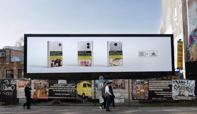 a billboard in Shoreditch with warnings against phone addiction for teens
