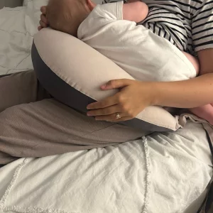 Hippychick nursing pillow in use with tester