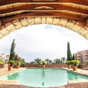 Holiday Village Majorca outdoor pool with stone archway