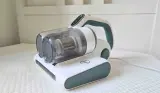 The Hoover HMC5 Mattress Vacuum Cleaner atop a white mattress in a child's bedroom