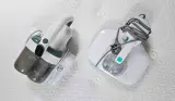 The Hoover HMC5 is on a bed next to Spring & Spruce's Mattress Maid