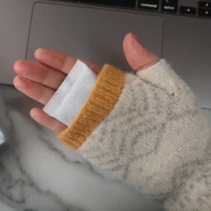 Hot Hands Instant Hand Warmers in a pair of fingerless gloves