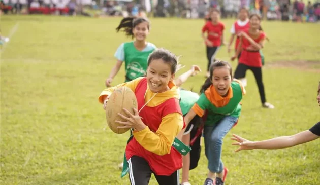 Girls playing rugby outdoors