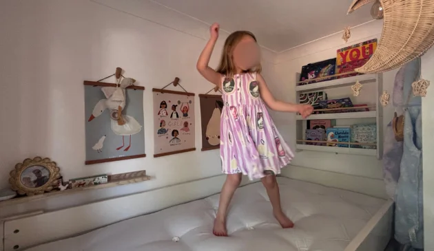 Child testing the Sealy Ortho Bronze Plus mattress