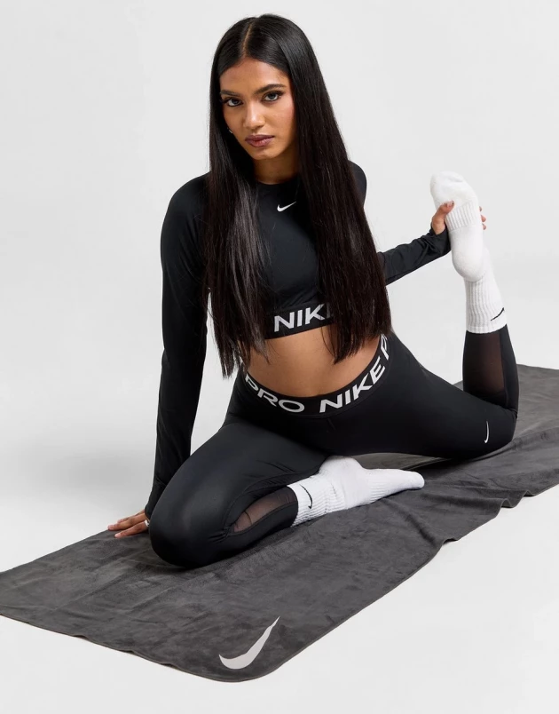 A model showcases the Nike Yoga Towel from JD Sports