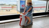 Toddler rides on a JetKids BedBox at an airport