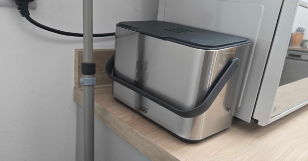 The Joseph Joseph food waste kitchen caddy next to a microwave