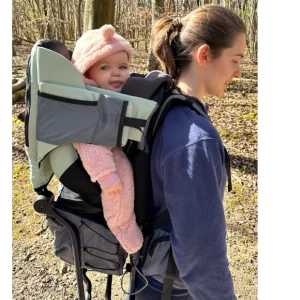 Mother and baby using Babymoov Moov & Hike Carrier in woodland