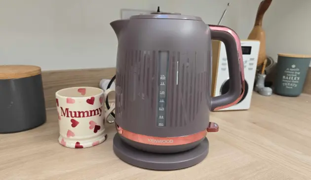 A view of the Kenwood Dusk kettle next to a mug that says Mummy in a kitchen