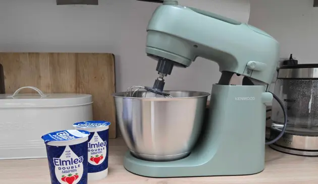A view of the Kenwood Go stand mixer on a kitchen worktop next to double cream