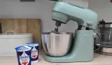 A view of the Kenwood Go stand mixer on a kitchen worktop next to double cream