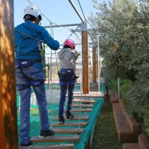 A child walking on a rope bridge at Kenzi Club Agdal Medina in Marrakech