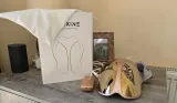 A shot of the KESKINE LED Face mask unboxed on a table