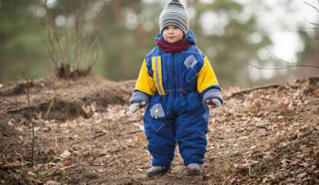 Toddler in chunky outdoor waterproofs