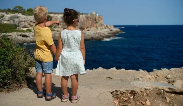 Kids looking out to sea in Mallorca