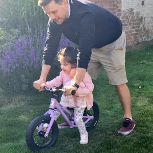 Little girl on early rider charger 12