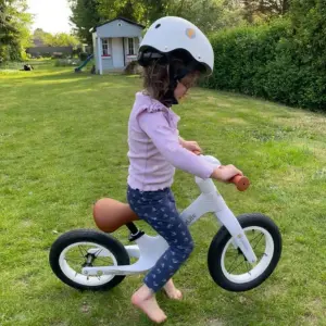 Child riding LittleLife Balance Bike in garden