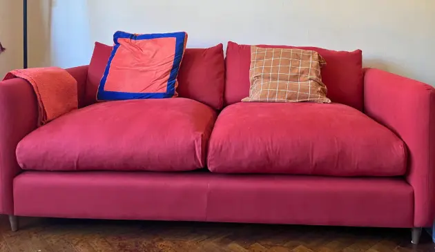 Red Loaf Squishmeister Sofa Bed with two large seat cushions and scatter cushions in a family living room
