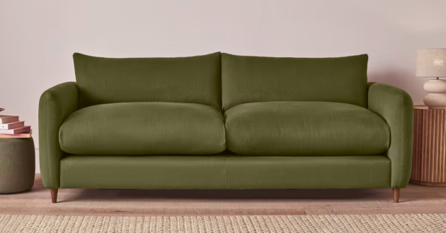 Green Loaf Squishmeister Sofa Bed shown closed in a styled living room