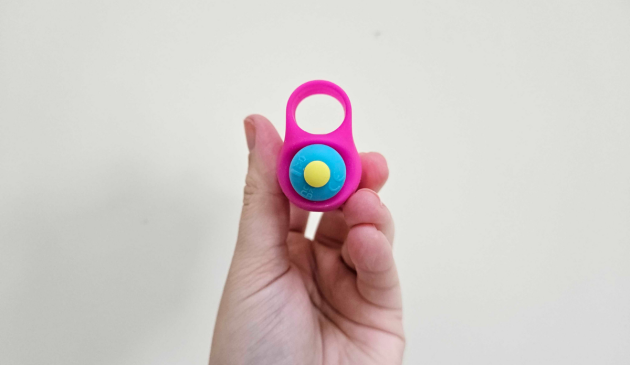 A side view of a hand holding the Lovehoney Excite 10 Function Finger Vibrator