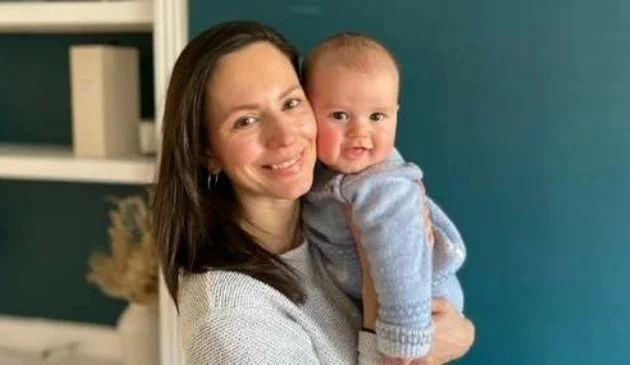 Woman smiling and holding baby