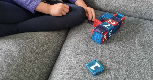 Child playing with MAGNA-TILES microMAGS LEARN Numbers