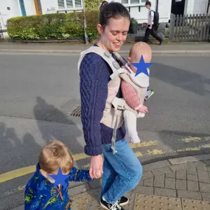 Mum wearing Mamas & Papas Kudo Baby Carrier