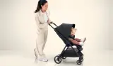 Woman pushing child in Mamas & Papas Libro Stroller