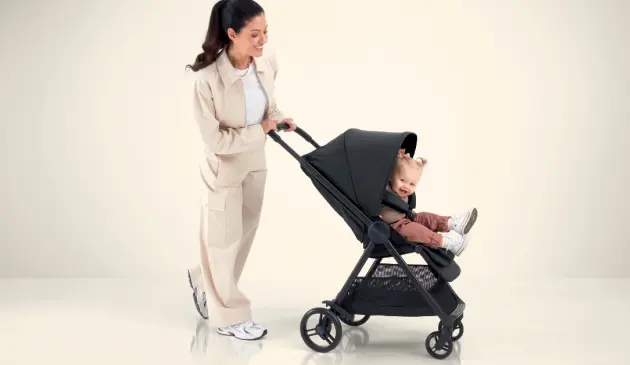 Woman pushing child in Mamas & Papas Libro Stroller