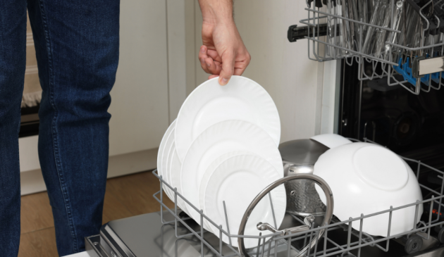 Man emptying pots from the dishwasher