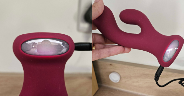 On the left, the light of the Mantric rabbit vibrator while it chargers and on the right, a hand holding the vibrator while it charges