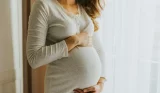 Woman holding baby bump