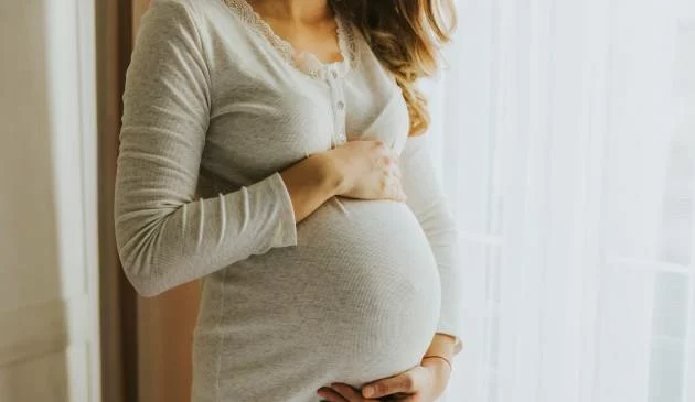 Woman holding baby bump