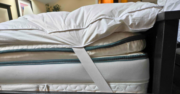 A side view of Soak & Sleep's topper that shows the strap