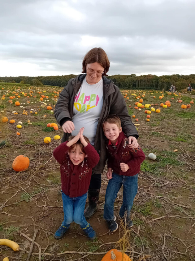 Mum Joanna and her two boys at a pumpkin picking patch