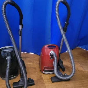 Miele Guard M1 Vacuum Cleaner next to the Miele C3 Cat & Dog Vacuum Cleaner