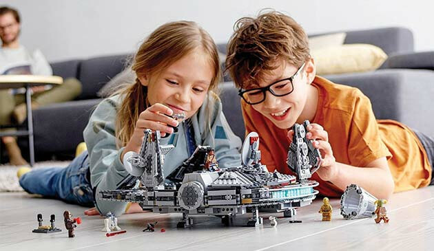 Children playing with Lego Star Wars Millenium Falcon