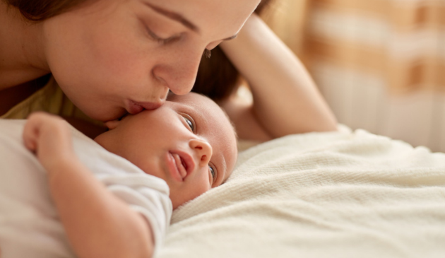 Mum lying with newborn
