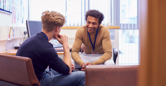 Teenage boy speaking to medical professional