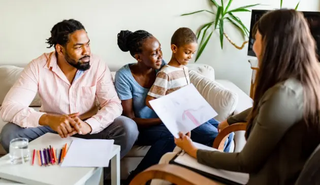 Mother and father with child at an assessment