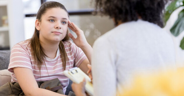 Teenage girl speaking to medical professional