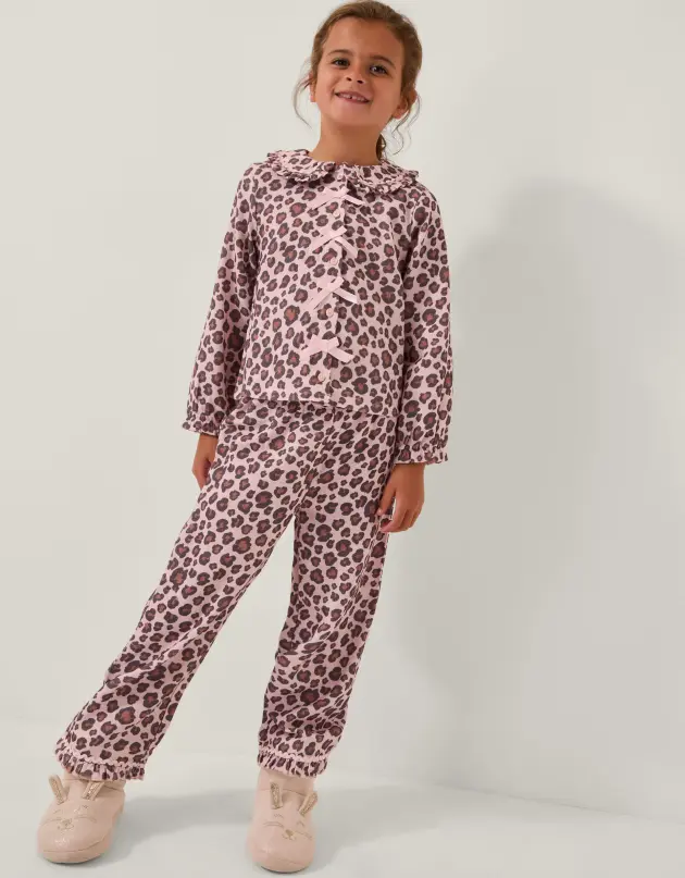 A young girl models Monsoon's Bow Leopard Print Long Pyjamas Set Pink pyjamas
