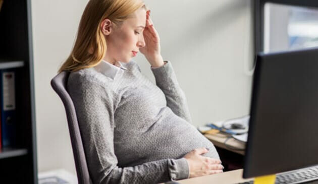 Pregnant woman at work feeling sick