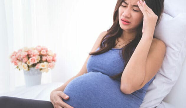pregnant woman feeling sick lying down