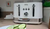 A view of the Morphy Richards Illumination Kettle atop a kitchen surface next to cucumber