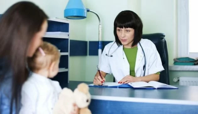 Mother and baby with a doctor