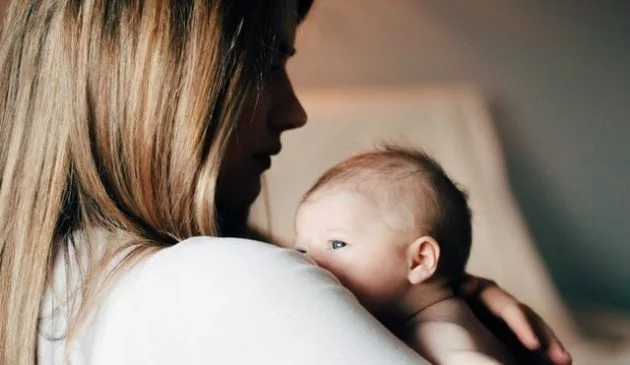 Mother holding a newborn baby in her arms